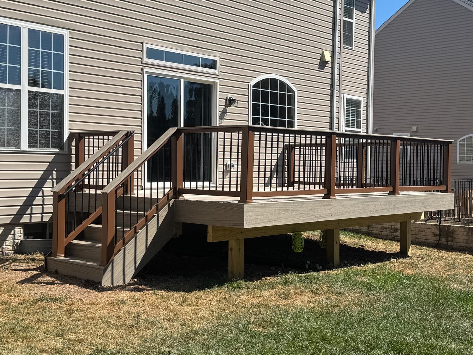 Custom outdoor kitchen with built-in grill and stone island in McLean