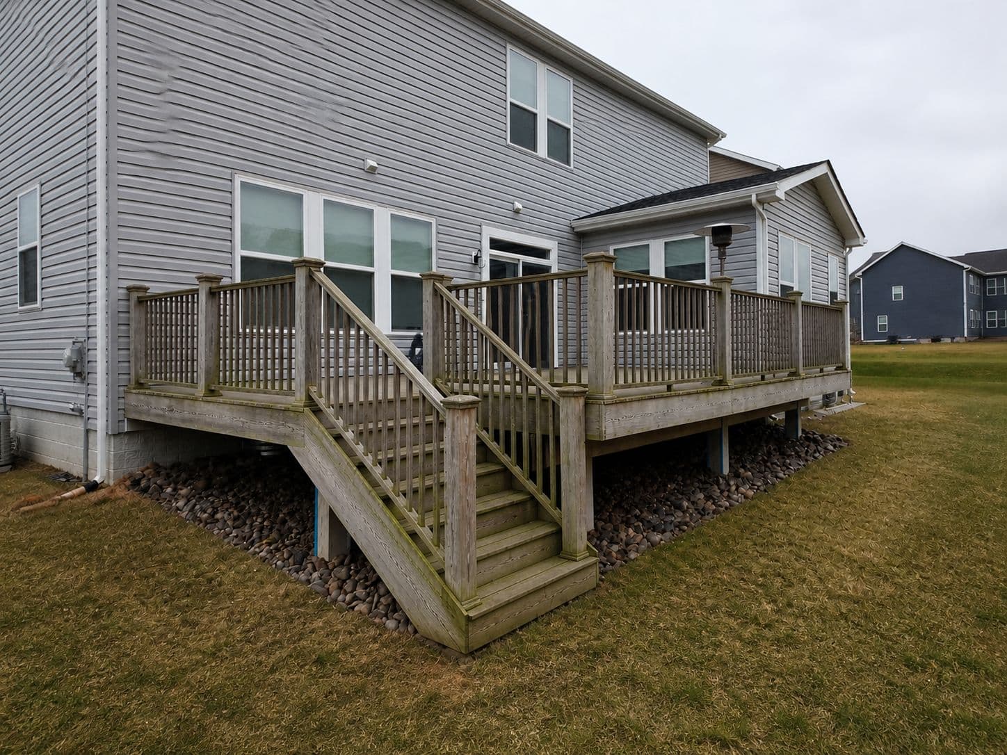 Weathered wood deck with traditional vertical balusters before resurfacing in Leesburg VA