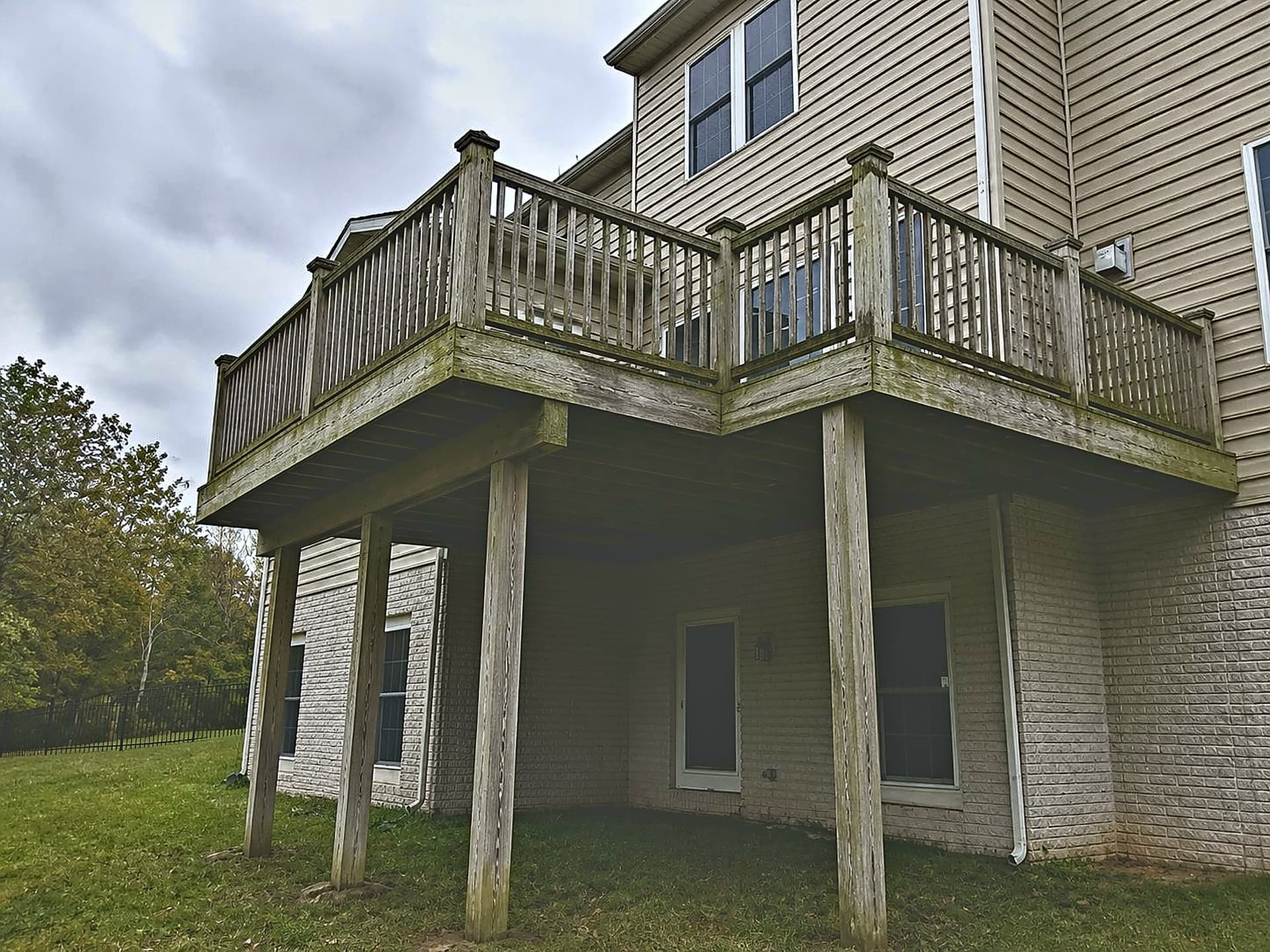 High-elevation wood deck with moss and algae growth before replacement in Ashburn VA