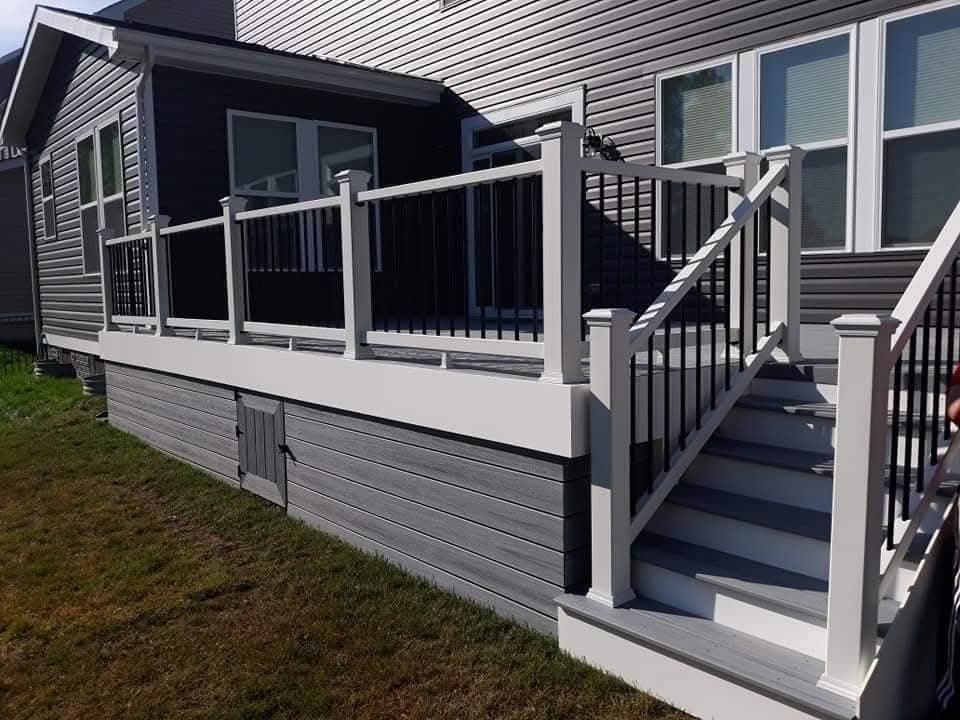 New gray composite deck with modern white railings and matching skirting in Manassas VA