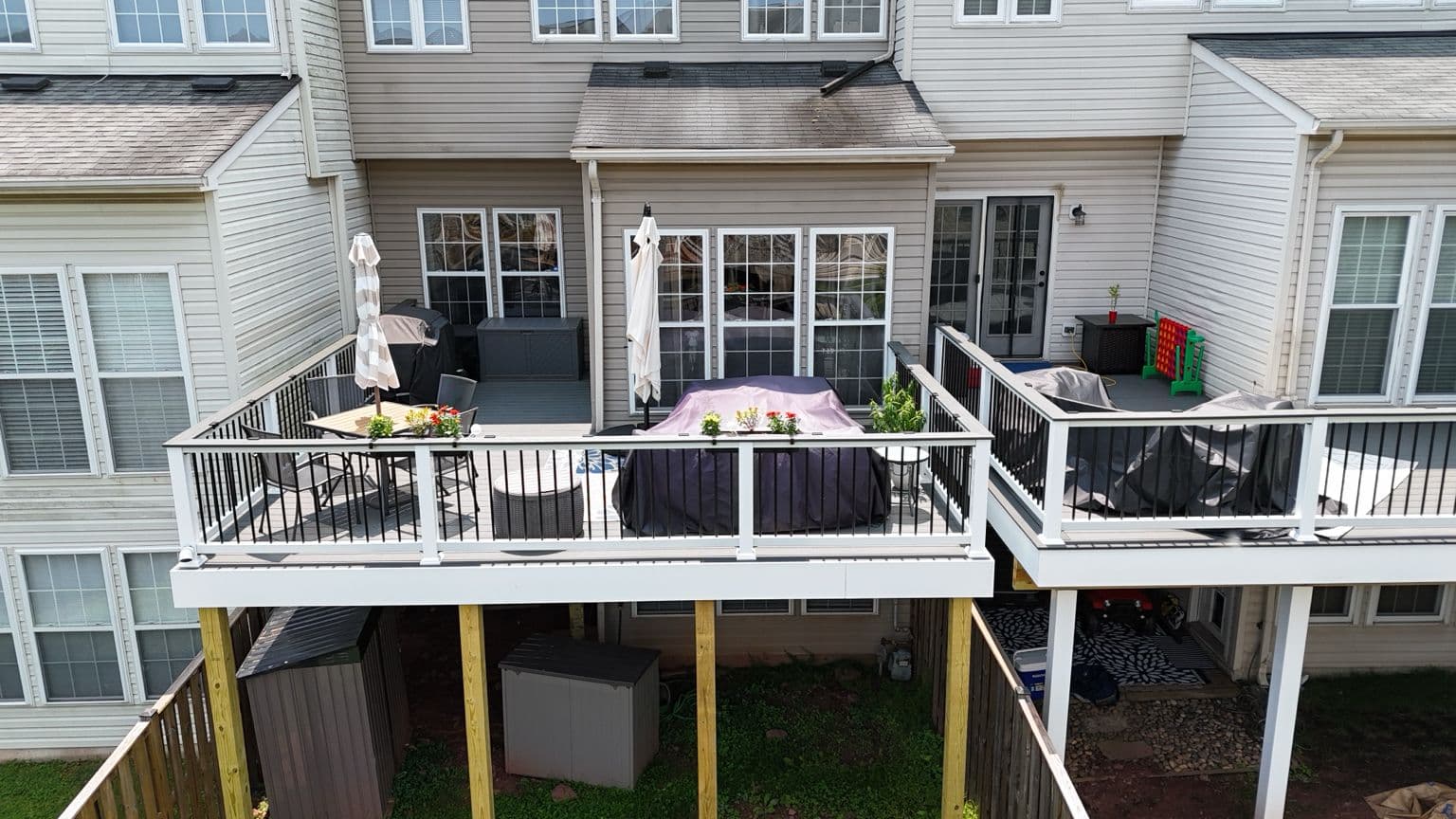 Modern white and gray composite townhome deck with black railings in Sterling VA
