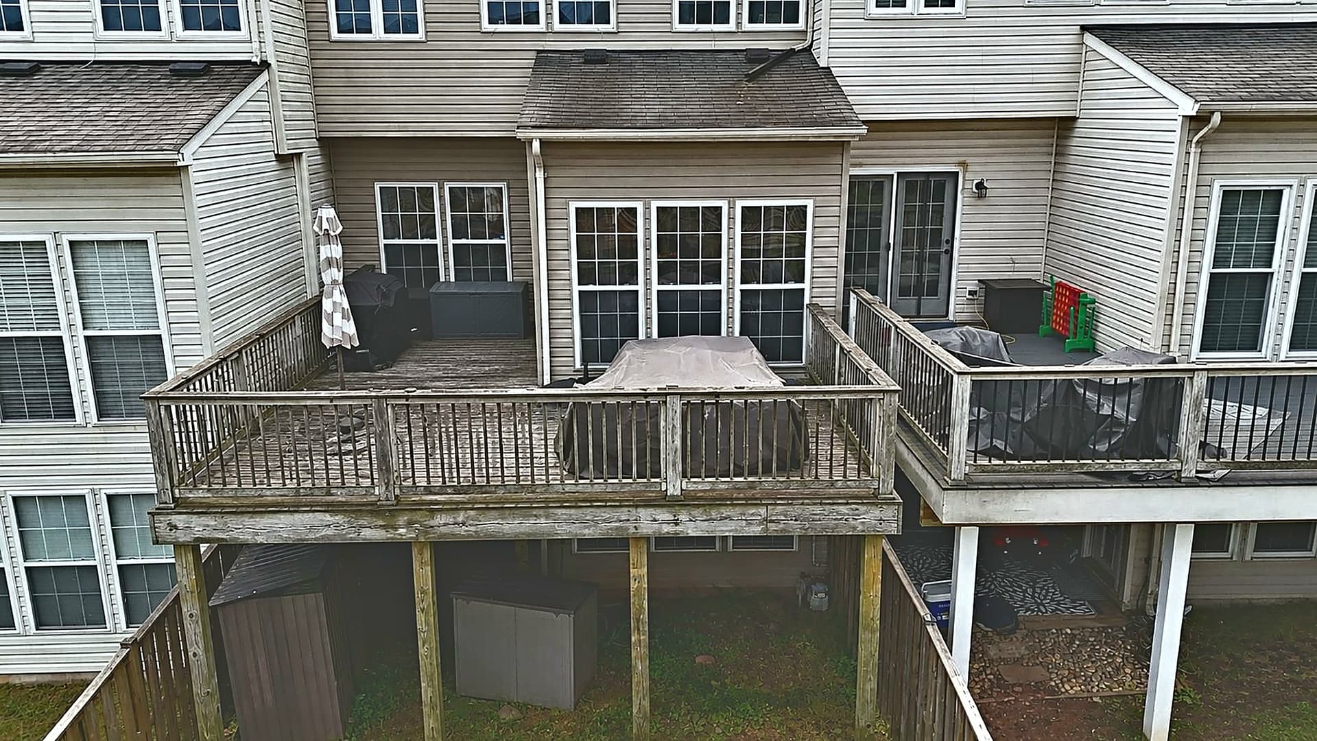 Worn townhome wood deck before full renovation in Sterling VA