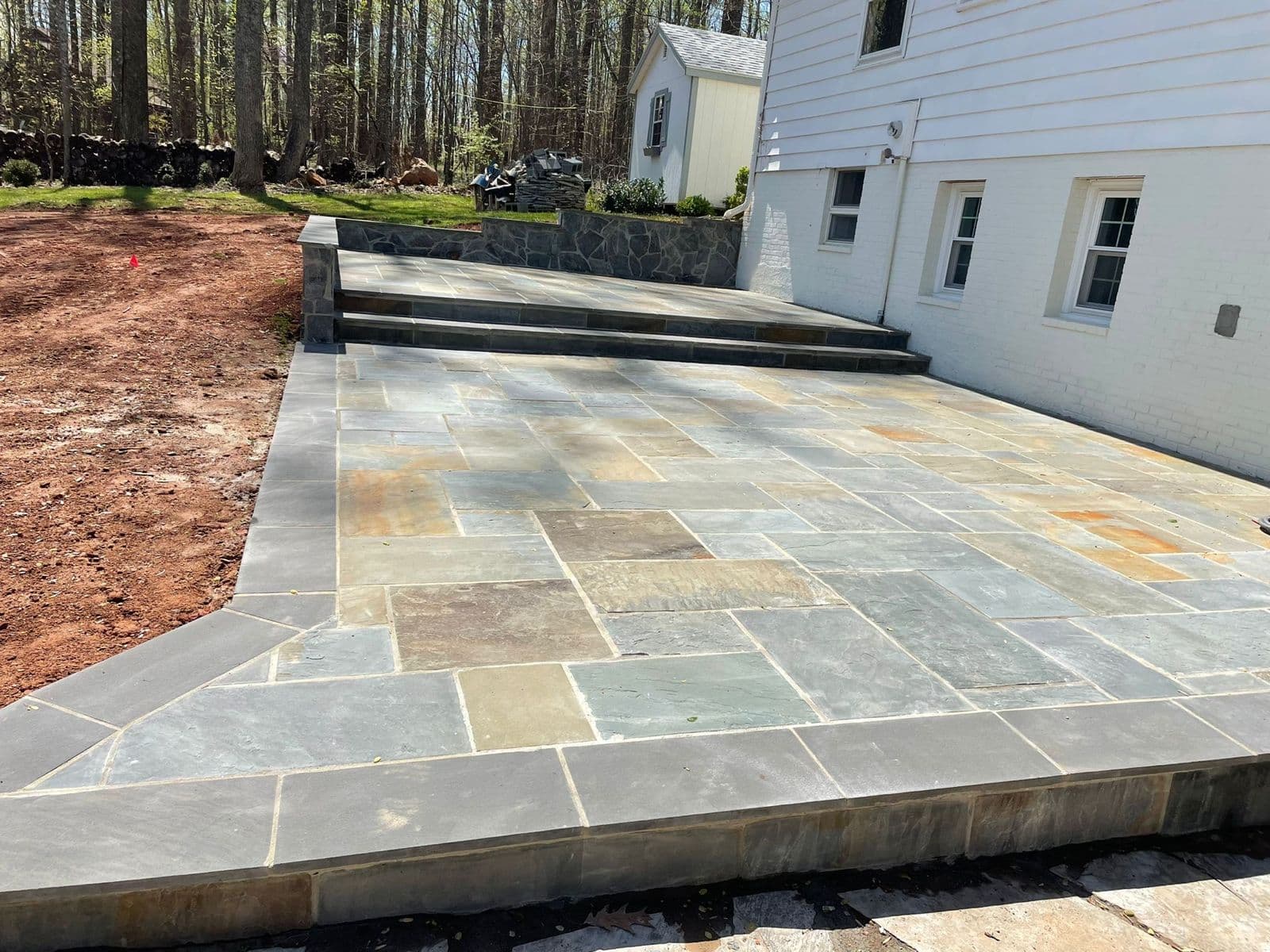 Premium natural stone patio with integrated fire feature โ Fairfax County