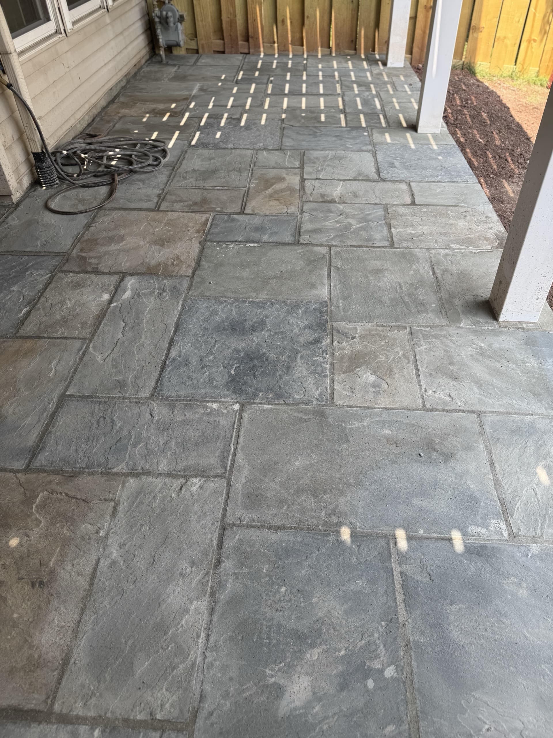 Hand-laid flagstone patio detail with polymeric joints โ NoVA luxury hardscape